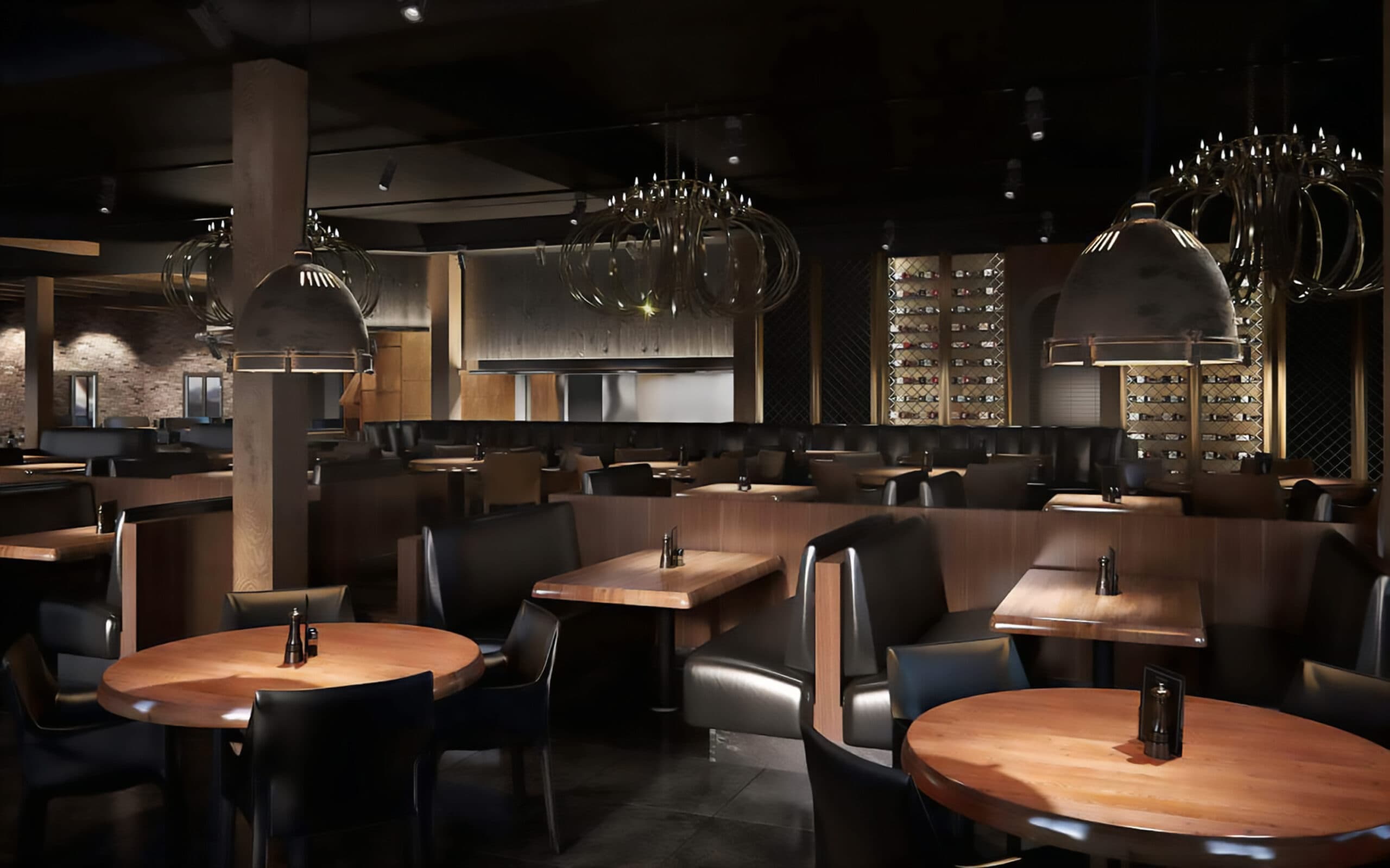 Restaurant interior with dim ambient lighting, wooden tables and black leather booths, a wine wall in the background and large stylized light fixtures.